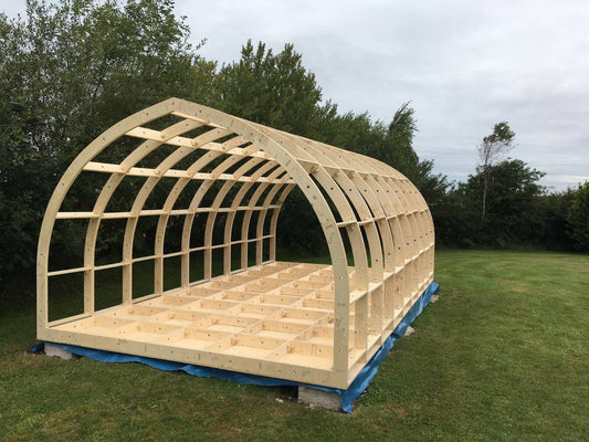 Shropshire CNC glamping pod frame kit, wide and high modular building with metal frame, measuring 6.0m x 3.4m x 2.99m, outdoors.