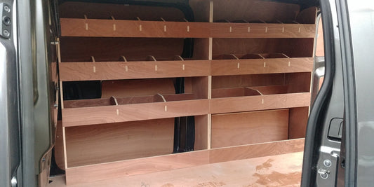 Peugeot Expert MWB van interior with plywood shelving and racking for efficient storage and organization of tools and gear.