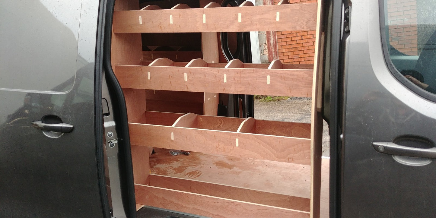 Toyota Proace LWB van with plywood shelving and racking system for storage and organization inside the vehicle.