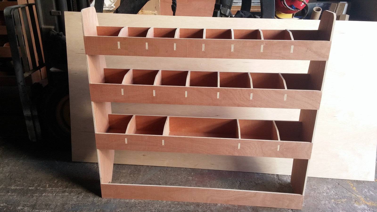VW T5 Transporter long wheelbase van with plywood shelving storage racks for efficient vehicle organization.