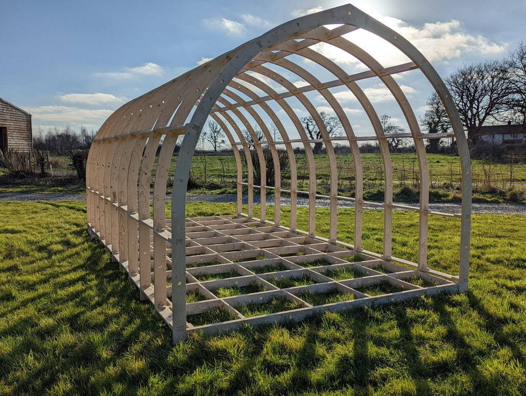 Shropshire CNC glamping pod frame kit, 3.95m wide modular building structure with wooden beams and metal connectors.