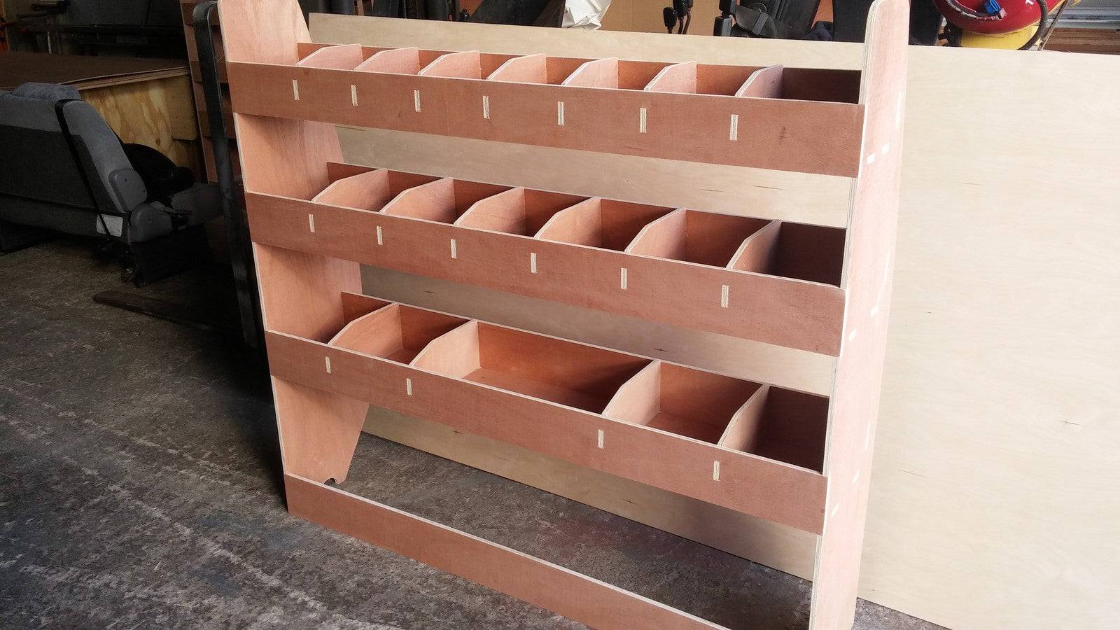 VW T5 Transporter LWB van plywood shelving racking system for storage and organization of tools and equipment inside the vehicle.