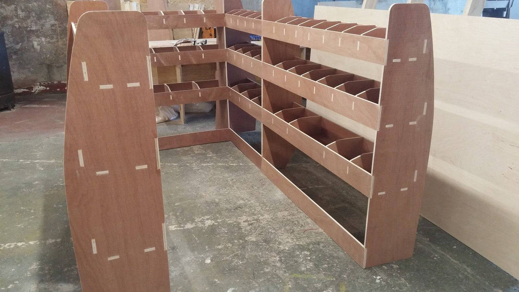 VW Transporter T5 long wheelbase van racking system with plywood shelves for storage and organization of tools and supplies.