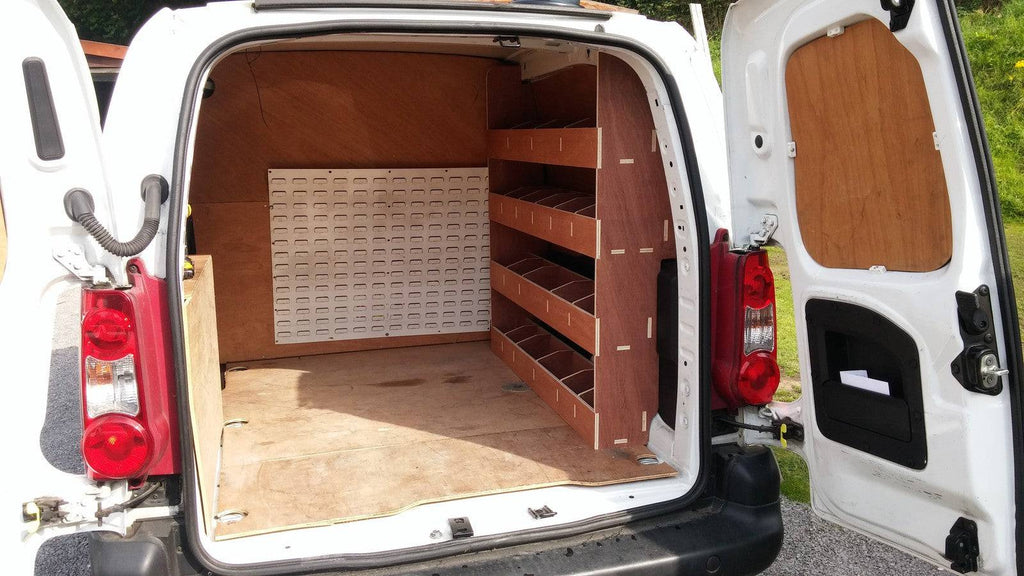 Peugeot Partner van racking with plywood shelving for tool storage, mounted inside the vehicle for organized commercial van storage.