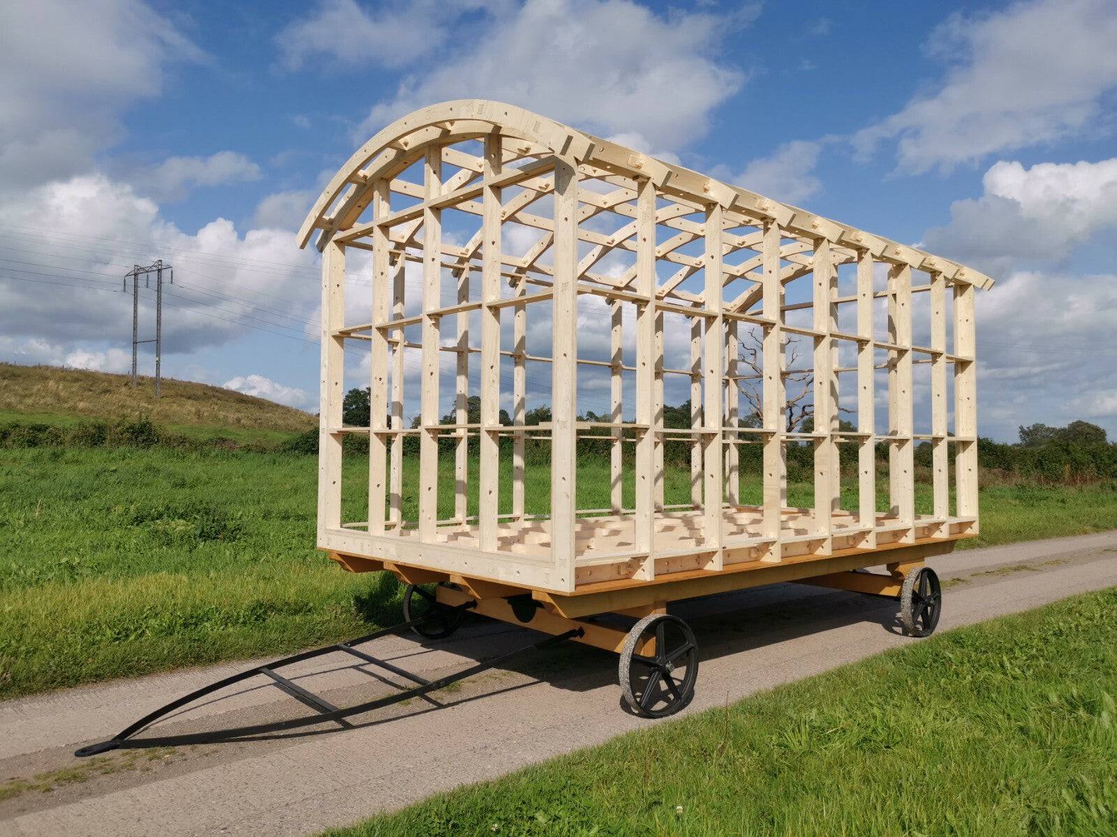 Shropshire CNC Shepherd's Hut Frame Kit showing assembled wooden structure with roof and walls for modular building project.