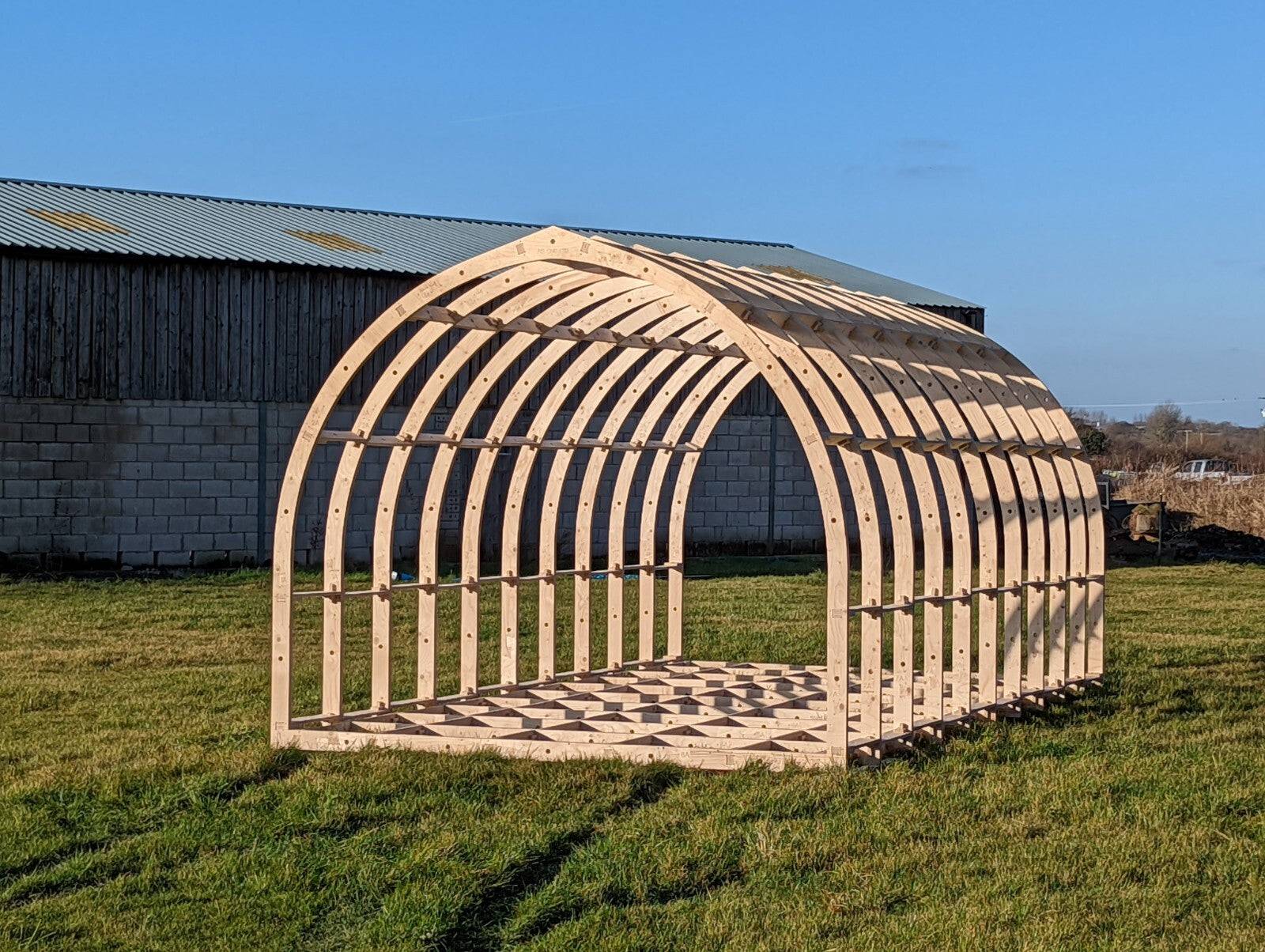 Shropshire CNC XL glamping pod frame kit, modular building structure with wooden beams, measuring 6.0m by 2.95m, ready for assembly.