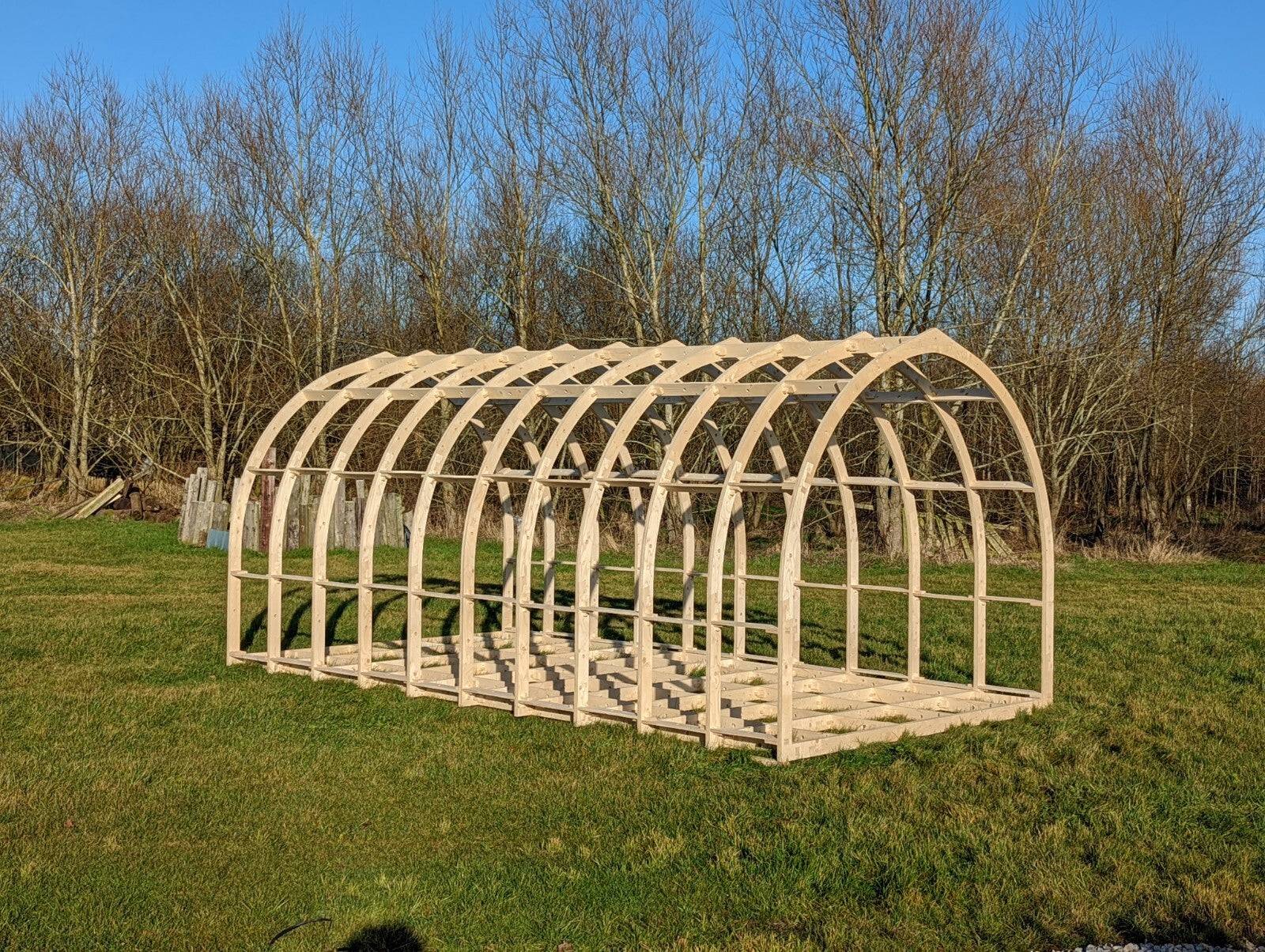 Shropshire CNC glamping pod frame kit, 3.95m wide, modular building structure with wooden beams and metal fittings.