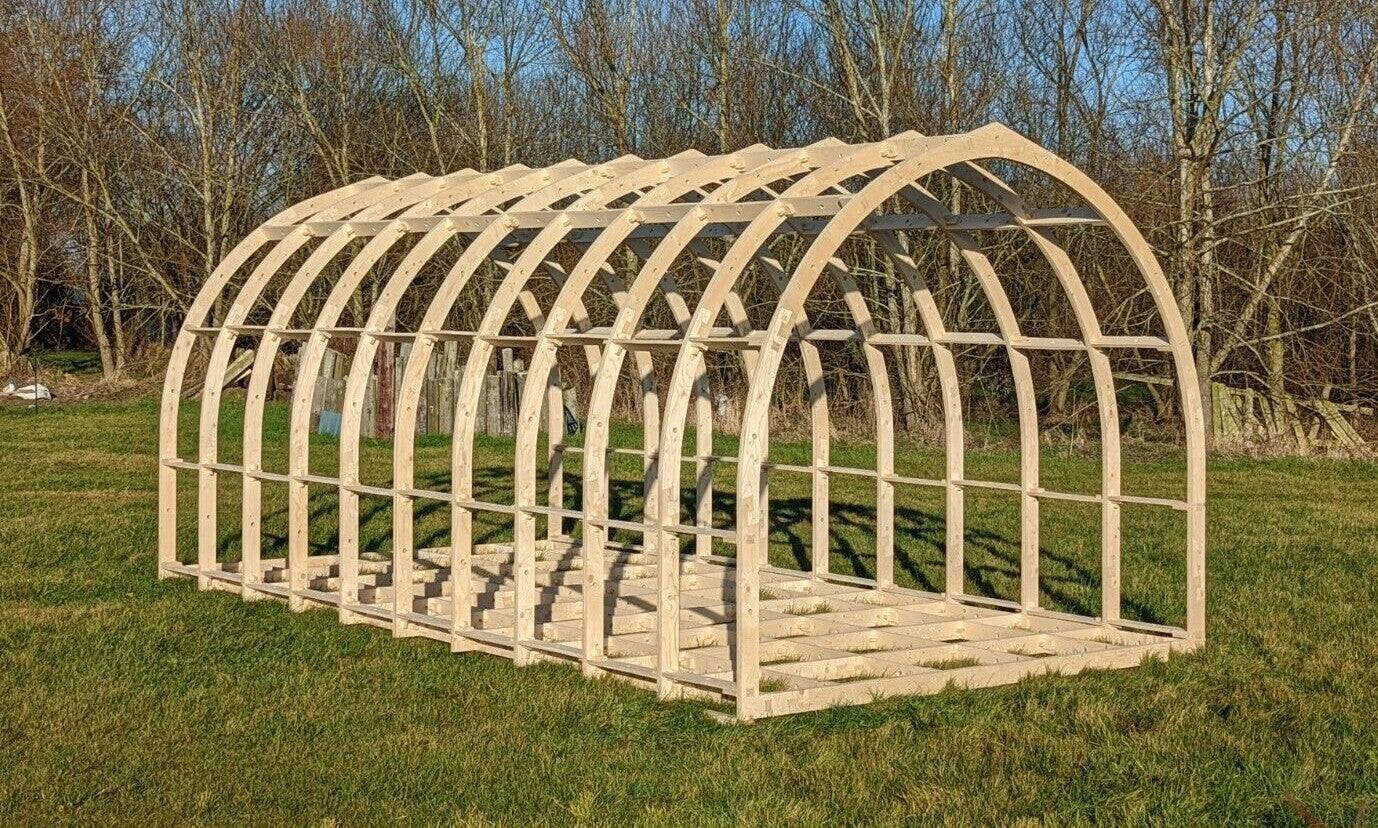 Shropshire CNC glamping pod frame kit, 3.95m wide modular building structure with wooden beams and metal connectors.