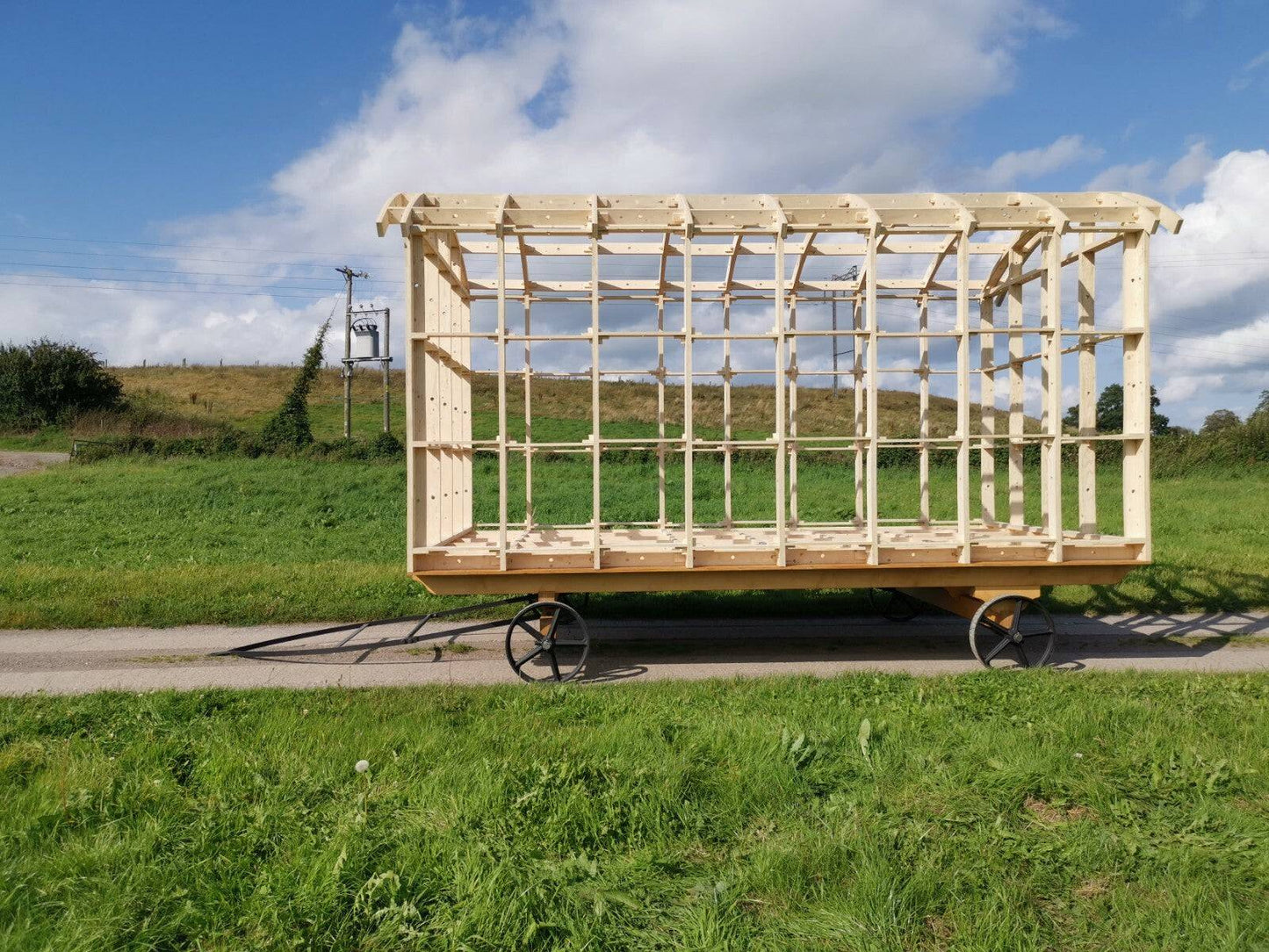 Shropshire CNC shepherd's hut frame kit with modular building components, showing the assembled wooden structure outdoors.
