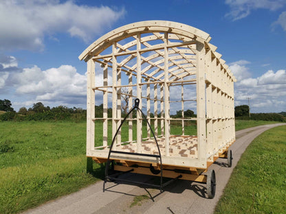 Shropshire CNC shepherds hut frame kit showing modular building structure with wooden beams and framing components.