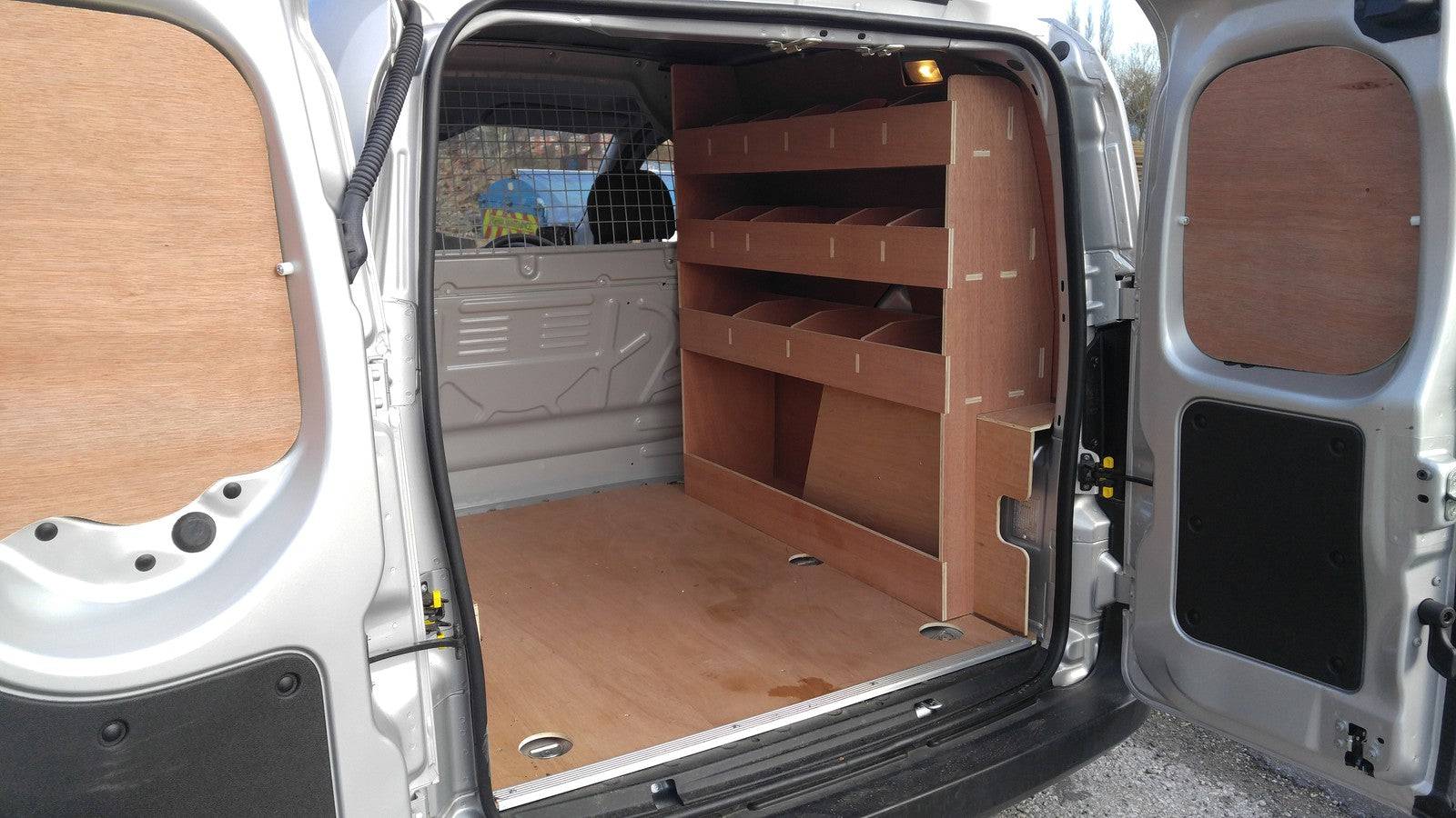 Fiat Fiorino van with plywood shelving and racking for organized commercial vehicle storage and van accessories.