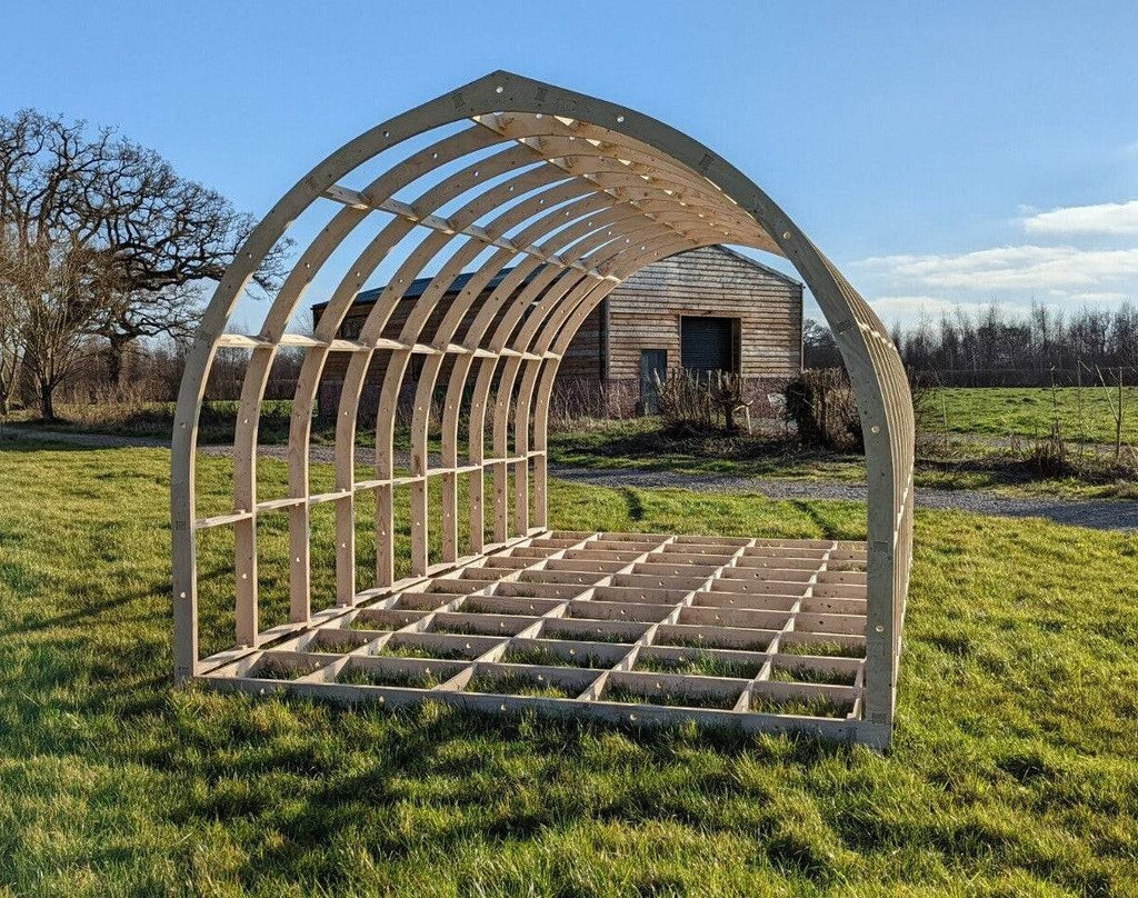 Shropshire CNC glamping pod frame kit in a 3.95m wide modular building with wooden panels and structural supports.