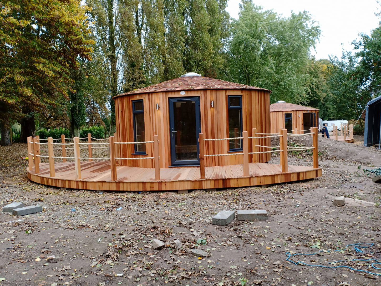 Shropshire CNC Yurt Pod Frame Kit, 4.2m modular building with wooden beams and structural components for outdoor accommodation.
