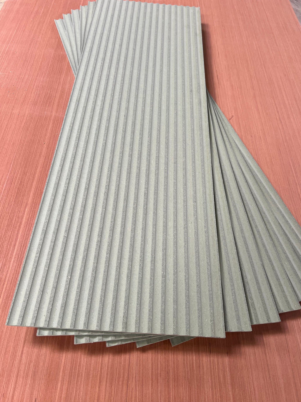 MDF 9mm fluted wall panel kit by Shropshire CNC showing assembled textured wall panels with vertical grooves on a wall surface.