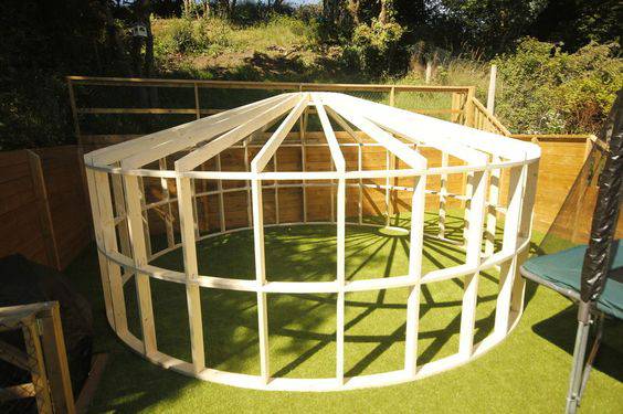 Shropshire CNC 4.2m Yurt Pod Frame Kit showing modular structure with wooden panels and metal supports for outdoor accommodation.