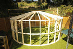 Shropshire CNC 4.2m Yurt Pod Frame Kit showing modular structure with wooden panels and metal supports for outdoor accommodation.