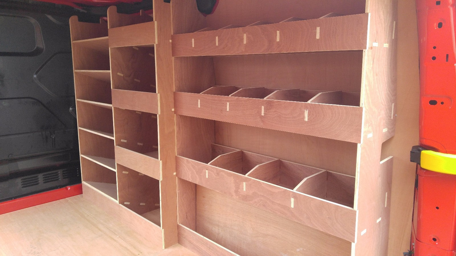 Ford Custom SWB plywood racking storage shelf system with pass side rear for commercial van or pickup vehicle interior.