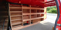 Ford Custom LWB van with plywood double racking drill and service case for deep storage in the vehicle cargo area.