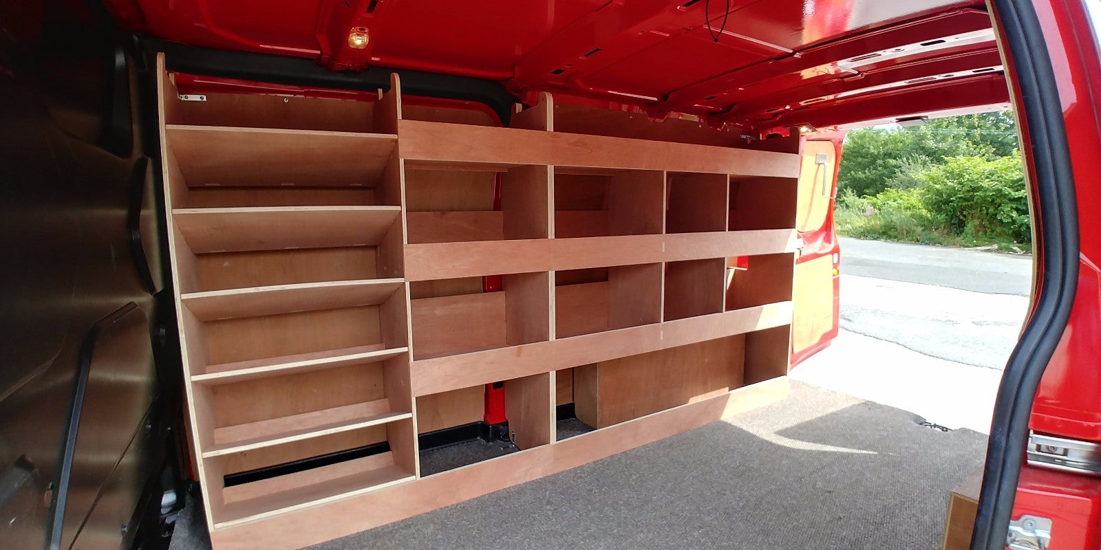 Ford Custom LWB van with plywood double racking drill and service case for deep storage in the vehicle cargo area.