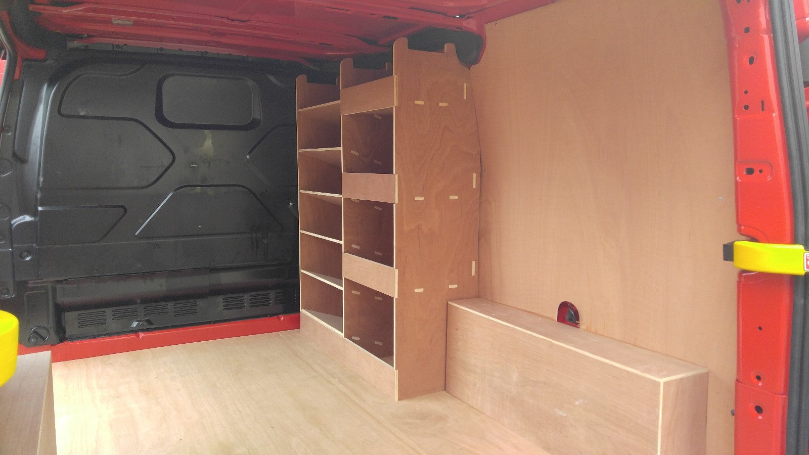 Ford Custom van racking with plywood shelving and deep storage drill/service case for commercial vehicle organization.