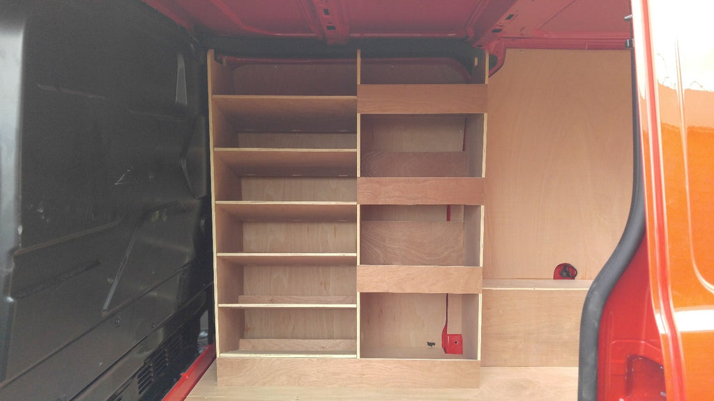 Ford Custom van racking with plywood shelving and deep storage drill/service case in a commercial vehicle setup.
