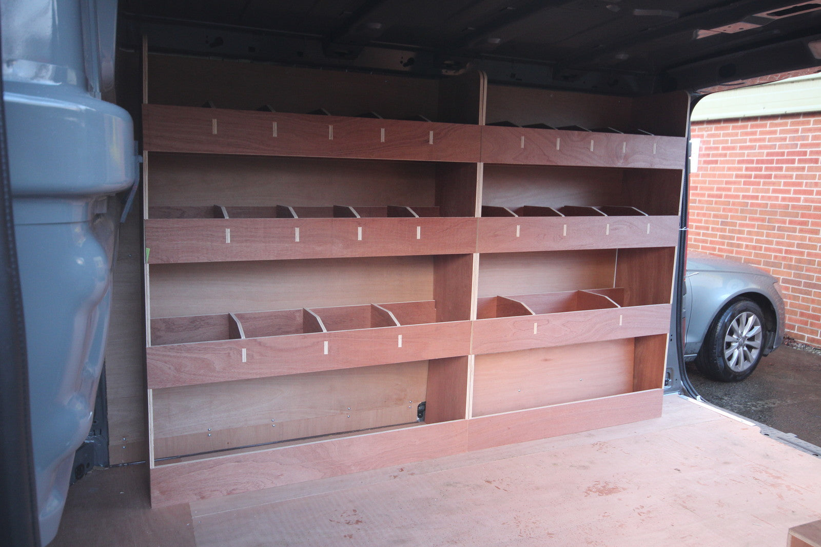 Nissan NV300 SWB 2015 van with double unit plywood shelving rack for commercial vehicle storage and organization.