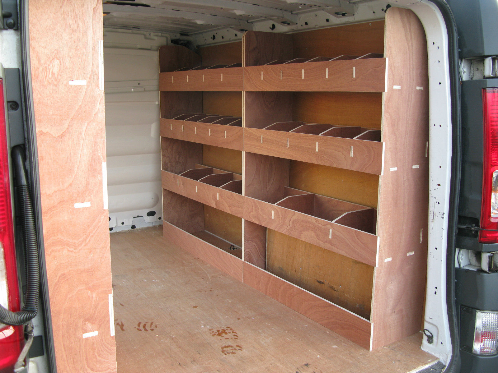 Renault Trafic SWB Van 2008-2013 interior with plywood shelving and racking for storage and tool organization.