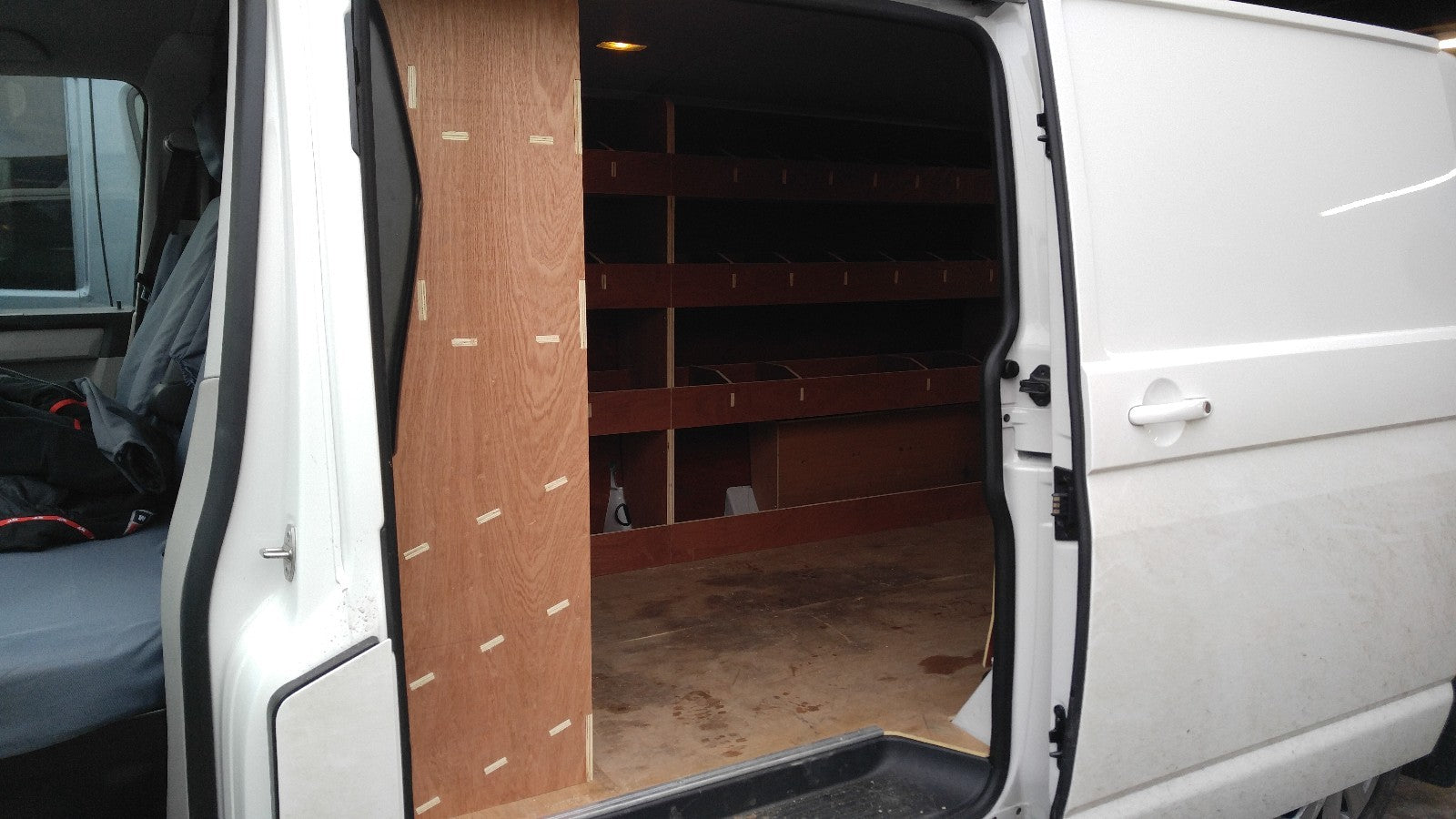 RS VW T5 T6 SWB triple van racking with plywood shelves for storage in commercial vehicle van or pickup interior.