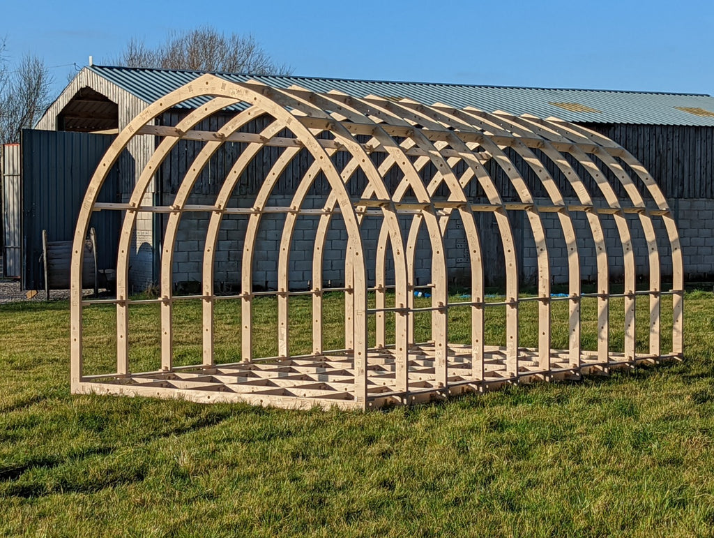 Shropshire CNC glamping pod frame kit, 3.2m wide, modular building structure with wooden beams and metal fittings.