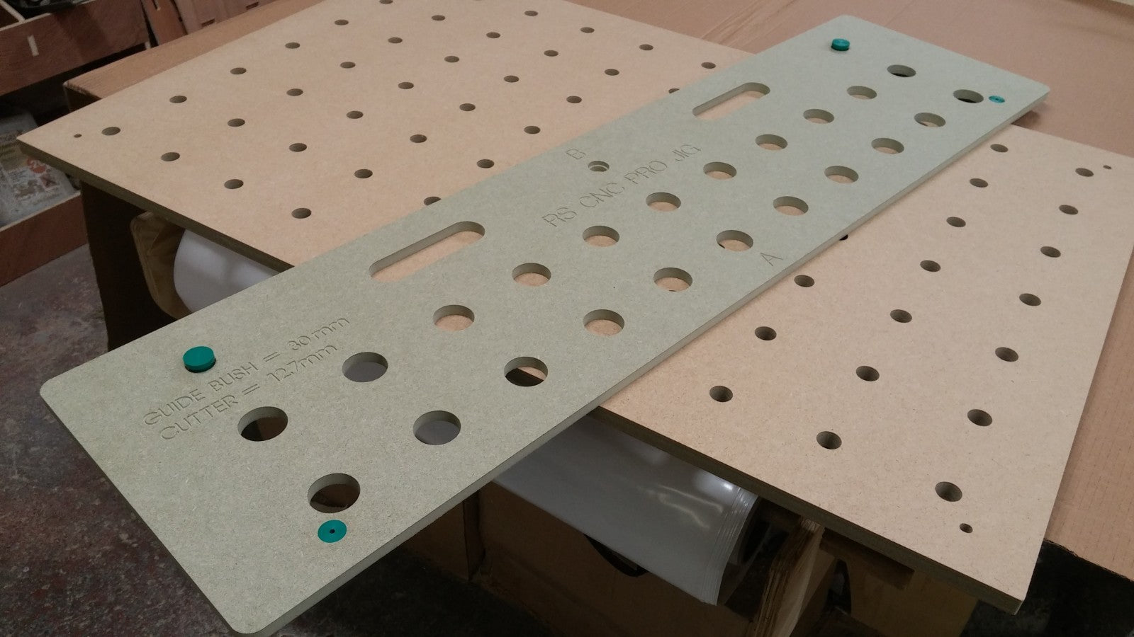 Shropshire CNC RS CNC PRO Jig for woodworking, made of MDF, used for precise drilling and assembly in workshop projects.