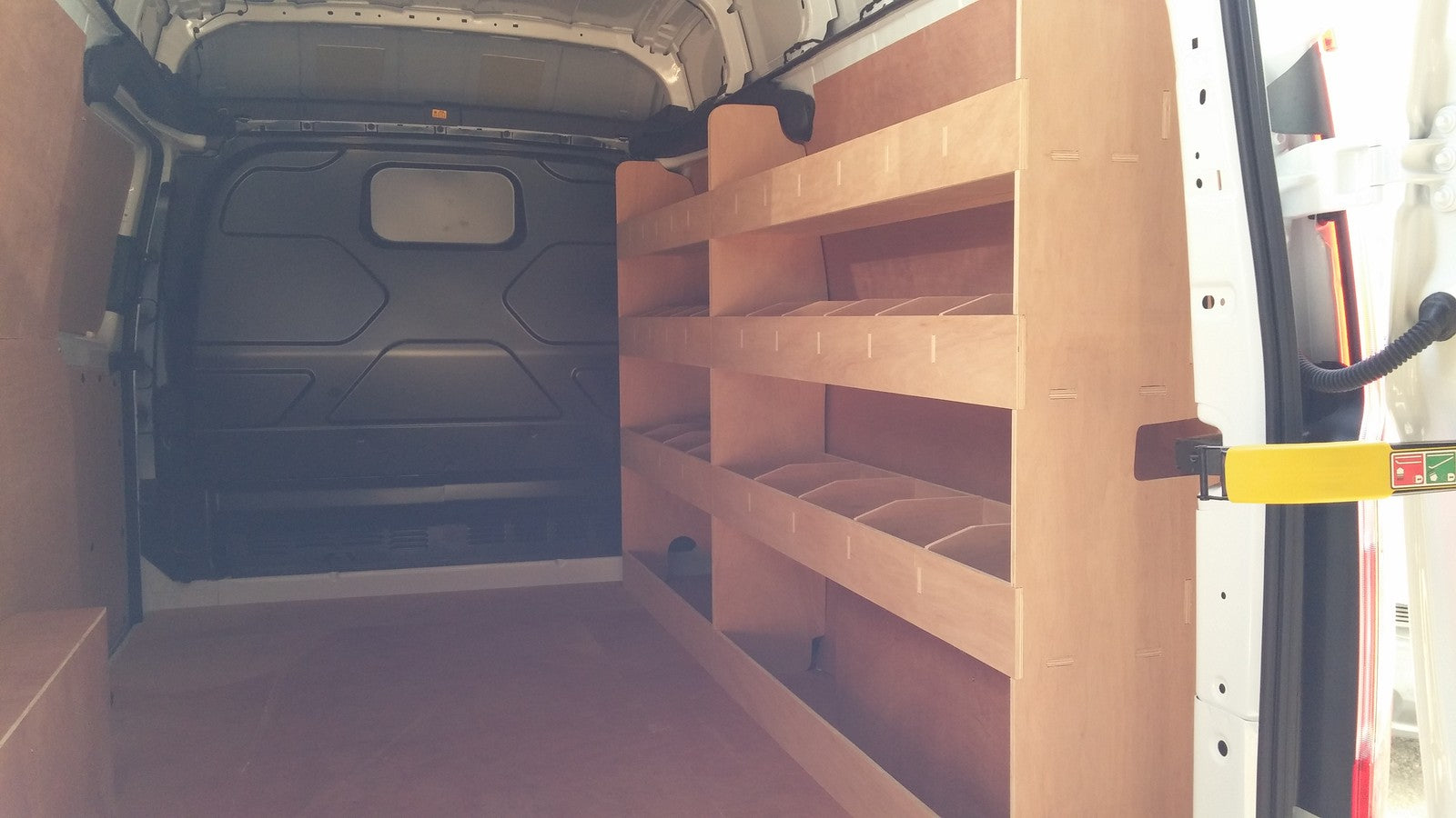 Ford Transit Custom LWB double van racking with plywood shelving for storage and organization of tools and supplies.