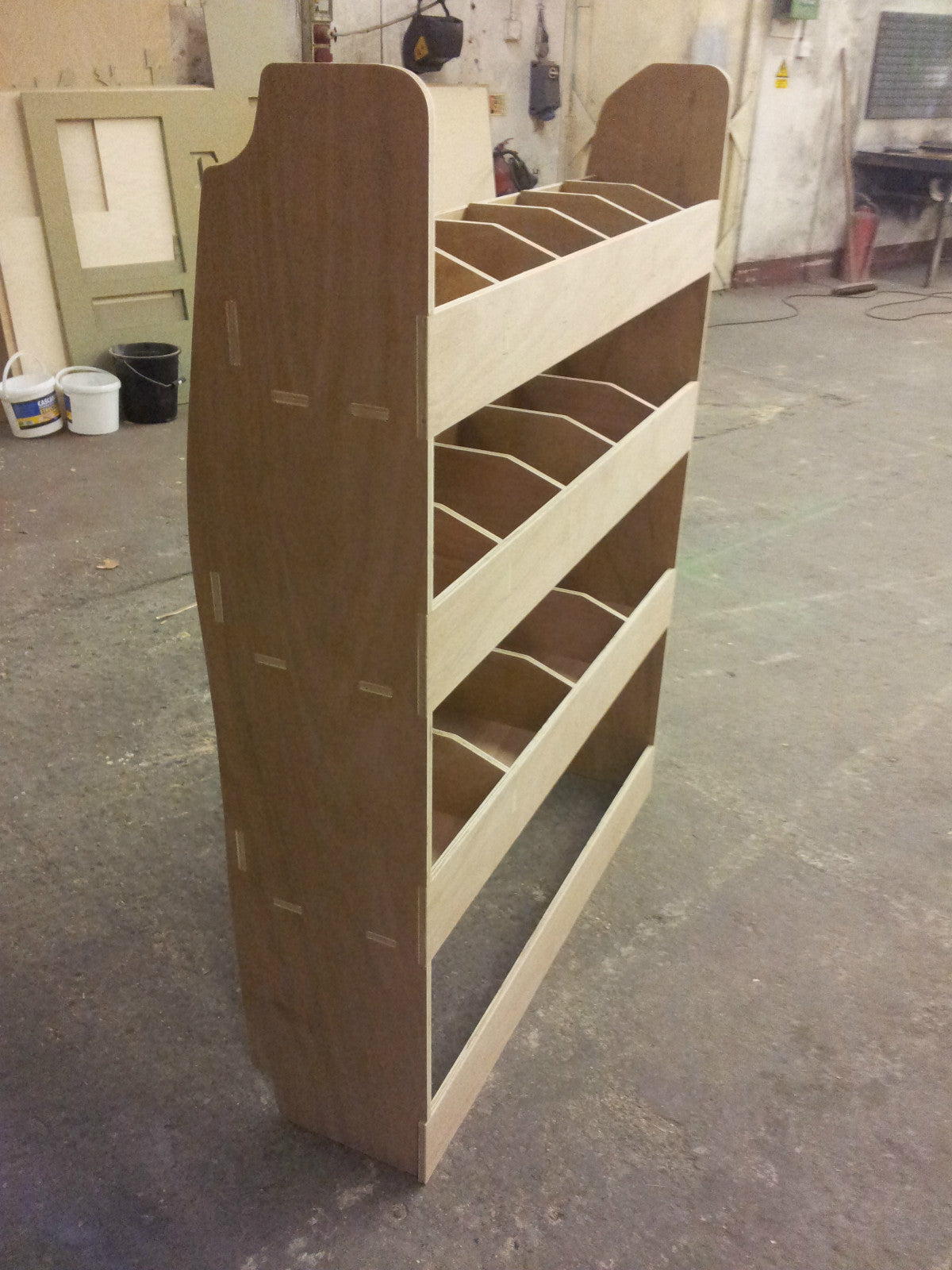 Transit Custom SWB van racking plywood tool storage rack with multiple shelves for organized van or pickup truck cargo.