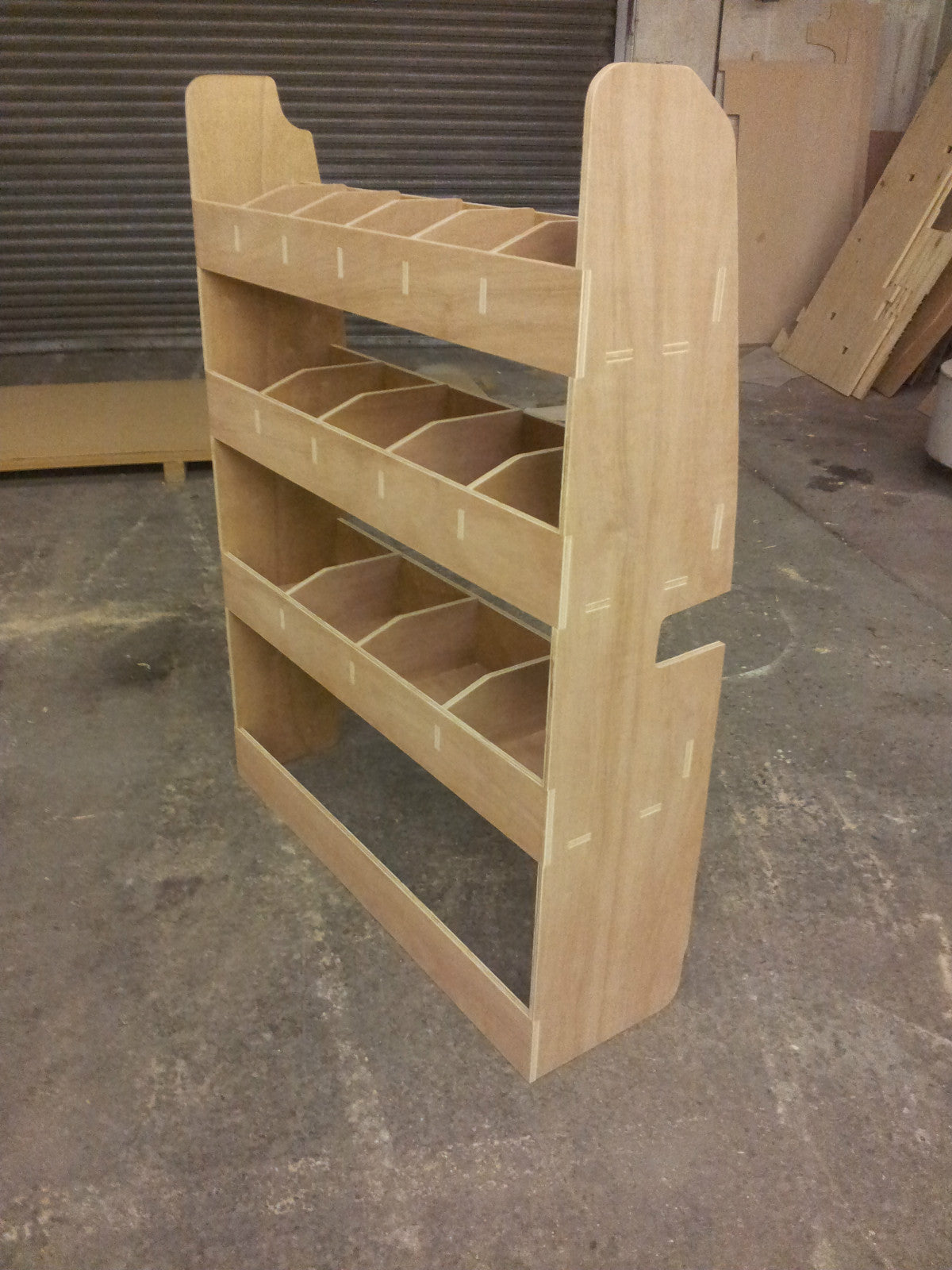 Plywood tool storage rack installed in a Transit Custom SWB van for organized van shelving and cargo management.