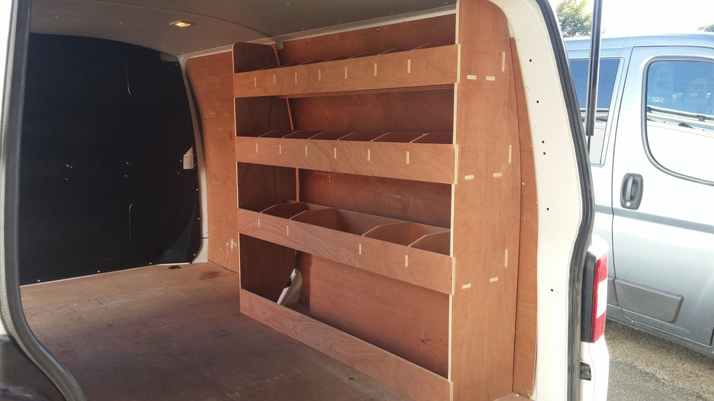 VW T6 Transporter LWB van racking with plywood shelving and tool storage accessories for commercial vehicle organization.